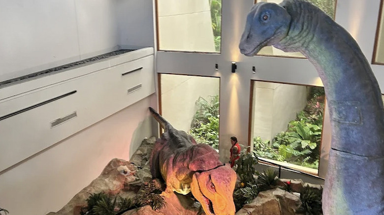 Dinosaur theming and huge windows inside The Burger Digs restaurant and Jurassic Park Discovery Center at Islands of Adventure.