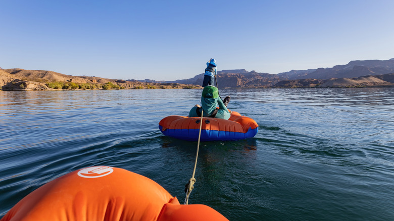 Visitors stand up paddle boarding on Lake Mead
