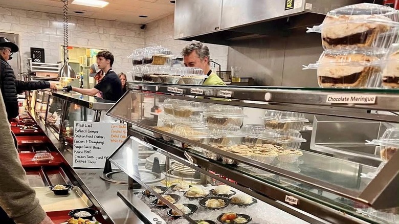 The steam tray table at Arnold's Country Kitchen with people lining up with trays of food