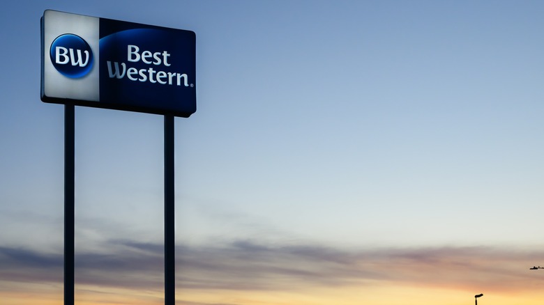 A Best Western sign against a sunset backdrop