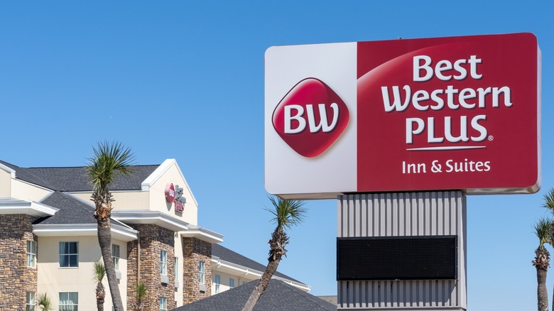 A Best Western Plus sign surrounded by palm trees