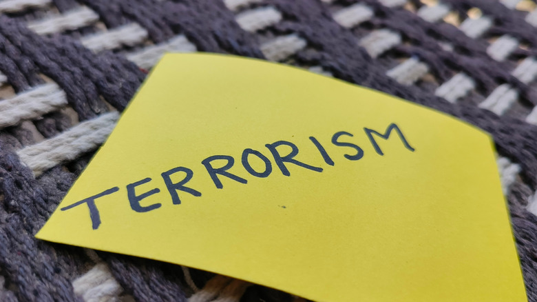 "Terrorism" written on yellow sticky note, close up