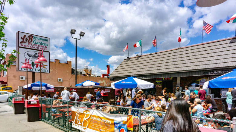 People eating outside L&B Spumoni Gardens