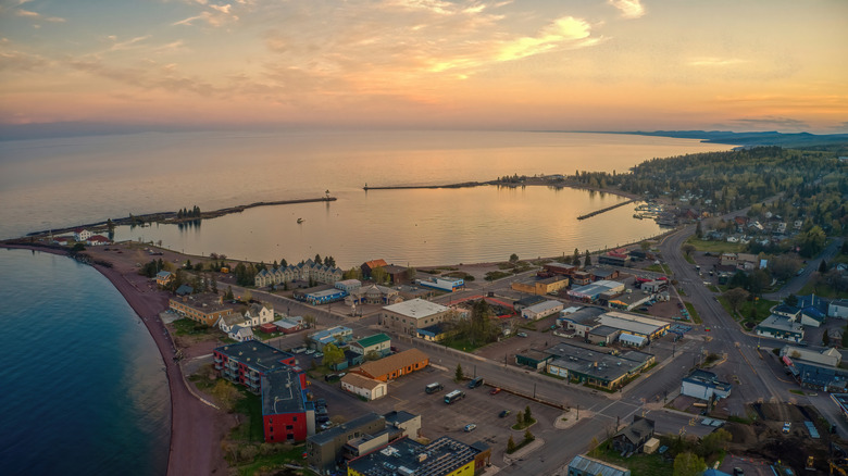 An aerial view of Grand Marais, Minnesota, and the Lake Superior shoreline at sunset