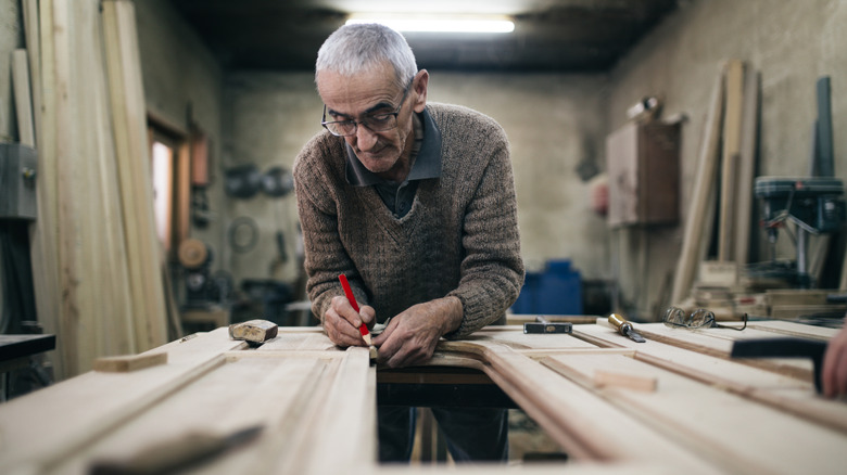 Elderly man working as a carpenter