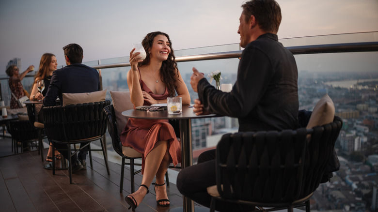 Well dressed couple eating in a restaurant