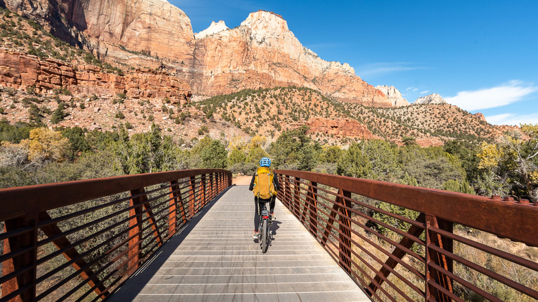 Woman on a relaxing bike ride on the Pa'rus Trail, enjoying the scenery of Zion