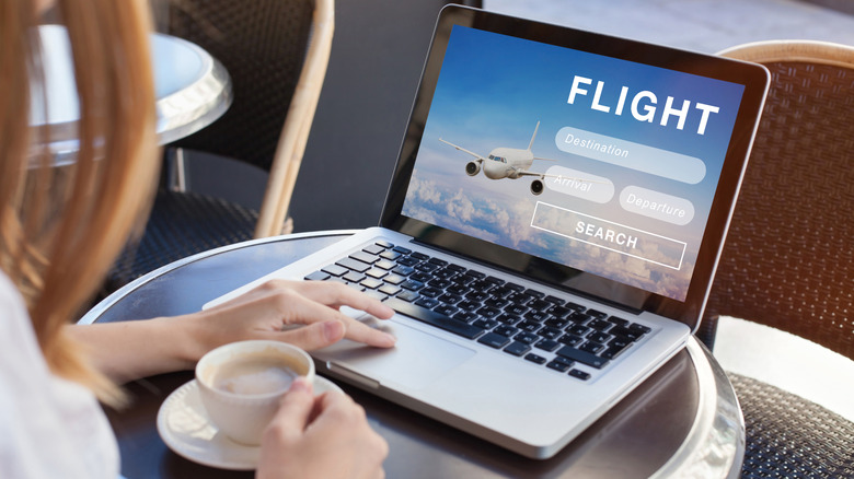 Woman facing a laptop screen with closeup of the flight booking page