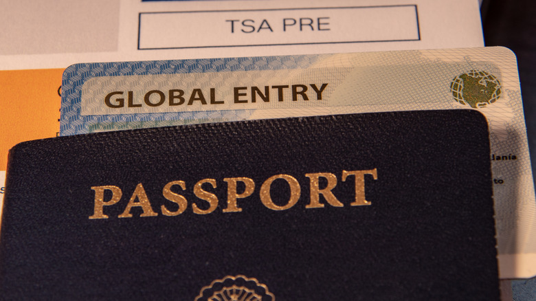 closeup of passport, boarding pass with TSA PreCheck and Global Entry card