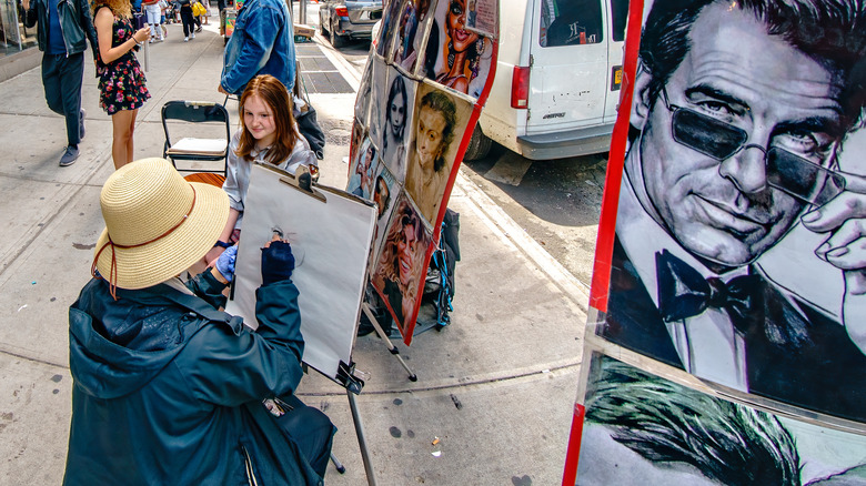 Girl poses for caricature artist