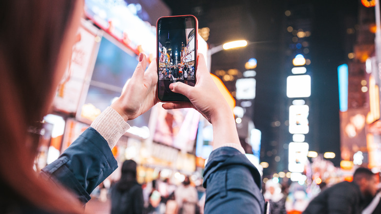 woman takes photo Times Square