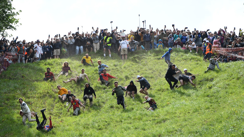 People running down grass hill