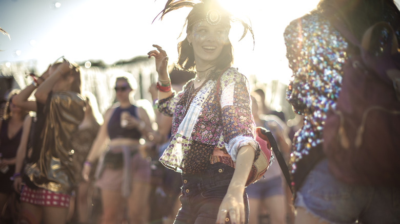 A woman dances with headdress