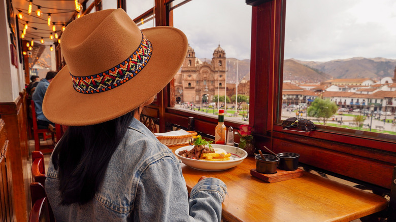 Tourist in a cafe overlooking the Plaza de Armas, Cusco