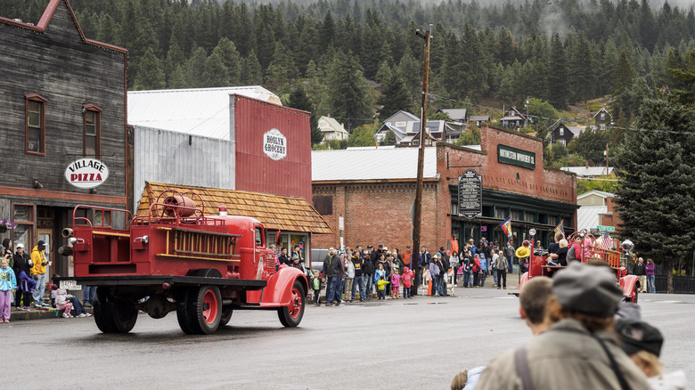 Labor day weekend parade attendees watch an old fire truck pass in historic old town main street of Roslyn, Washington