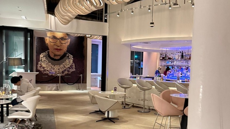 The bar of Hotel Zena Washington, D.C., with a wall mural depicting Ruth Bader Ginsburg