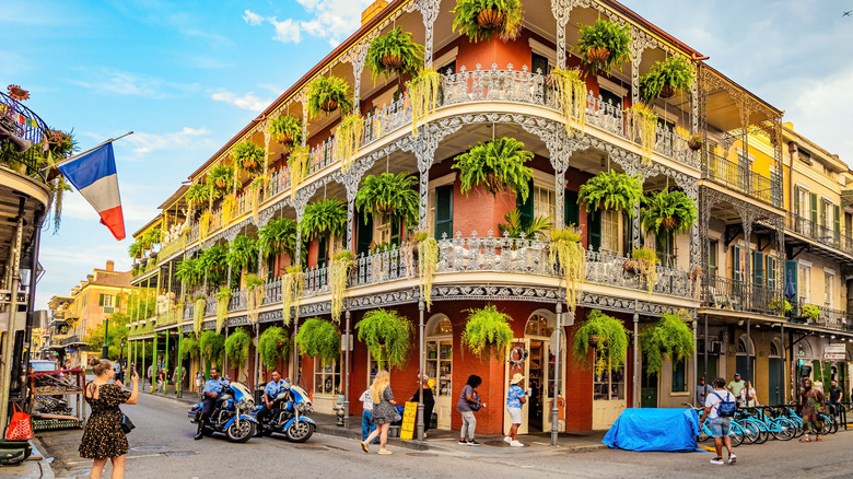 building with plants hanging from balcony in French Quarter