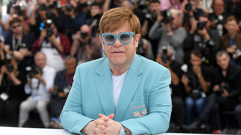 Elton John in a powder blue outfit at Cannes