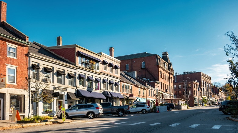 Main Street in Belfast, Maine with rows of shops on the left side.