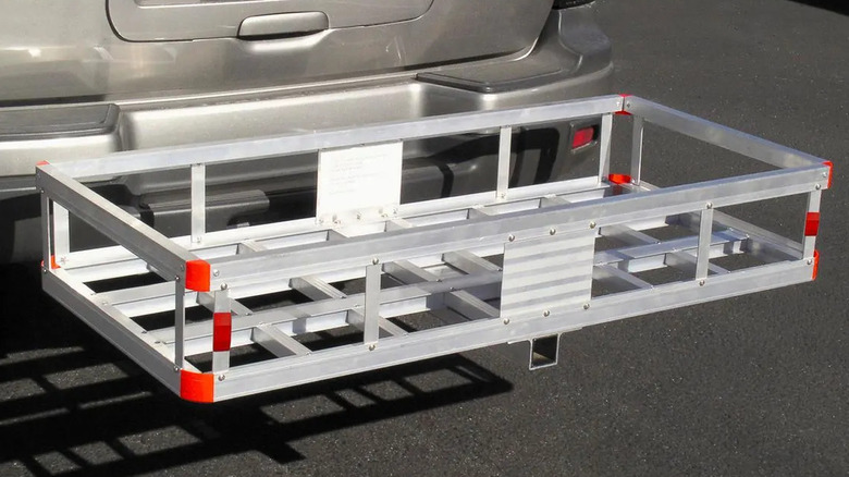 An aluminum cargo rack attached to the back of a vehicle