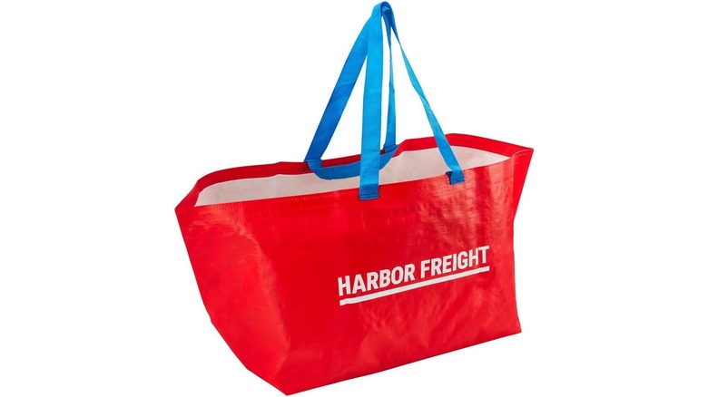 A large red carrier bag that reads "Harbor Freight" with blue handles on a white background