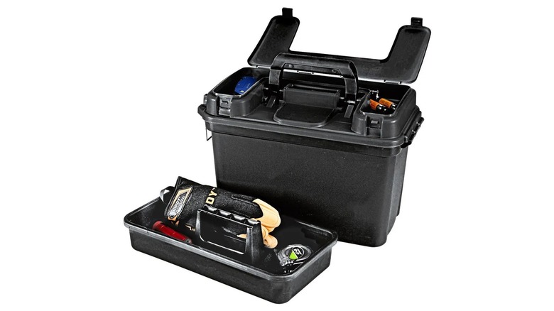 A black utility box full of gloves and tools on a white background