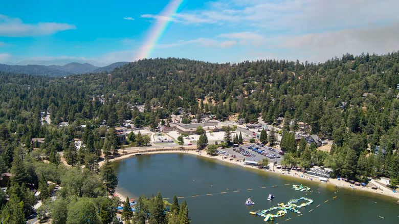 Lake Gregory in Crestline, California with the Sierra Nevada Mountains in the backdrop underneath a rainbow