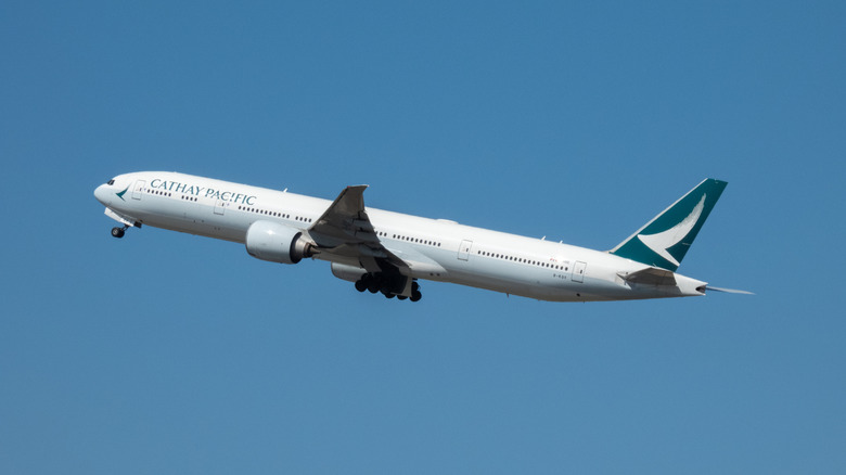 A Cathay Pacific 777 plane taking off into the sky