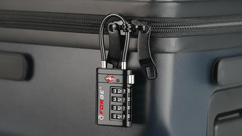 A Forge Optimus TSA-Approved 4-Digit Combination Lock securing a suitcase.