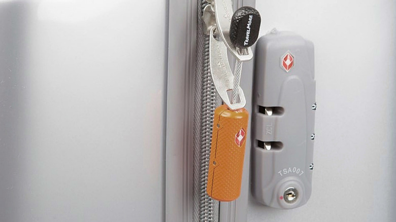 The TravelMore TSA-Approved Mini Key Padlock attached to luggage.