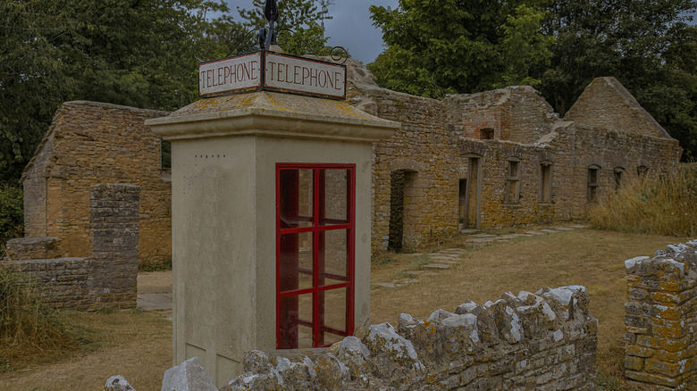 Abandoned telephone booth and building in Tyneham