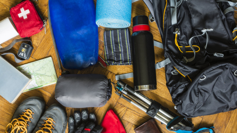 Equipment that would fit into a backpack to go out on a trail in the mountains