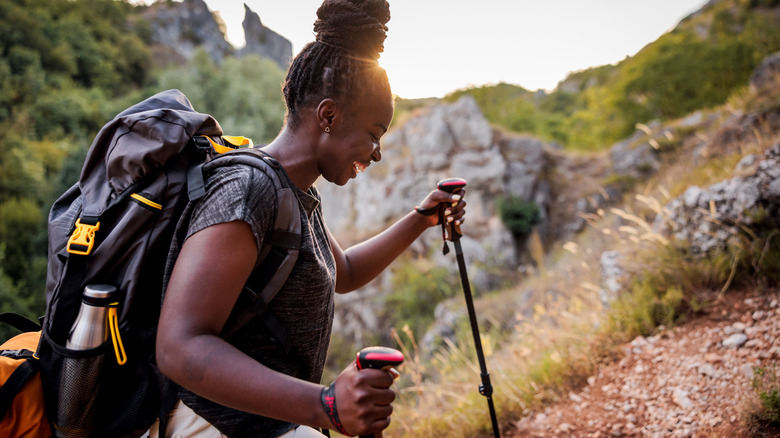African American female hiker with a large backpack exploring nature
