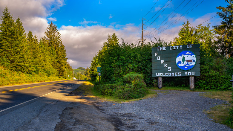 Welcome sign for the City of Forks, surrounded by dense forest of Olympic Peninsula
