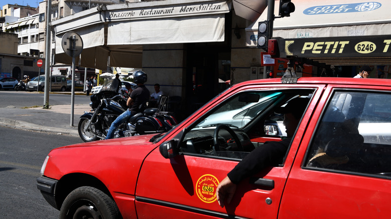Red taxi outside restaurant, Casablanca, Morocco