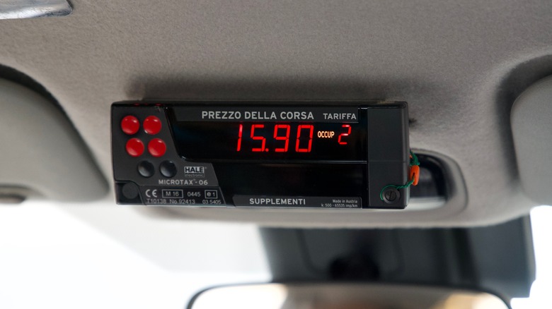 A taxi meter showing 15.90 in Rome, Italy