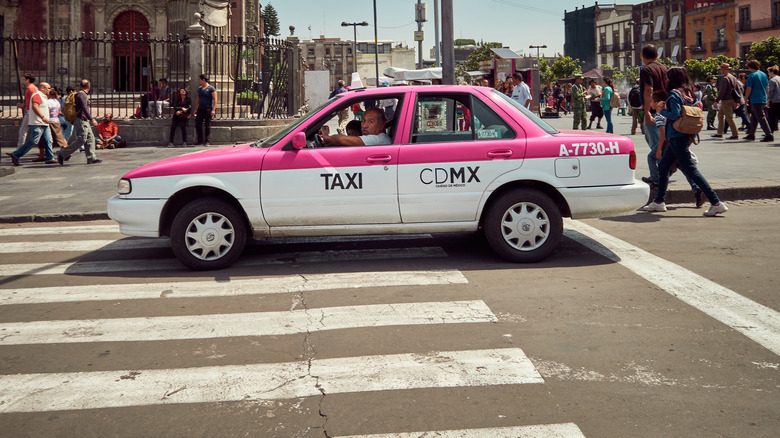 Pink and white CDMX taxi near cathedral and Zocalo in Mexico City
