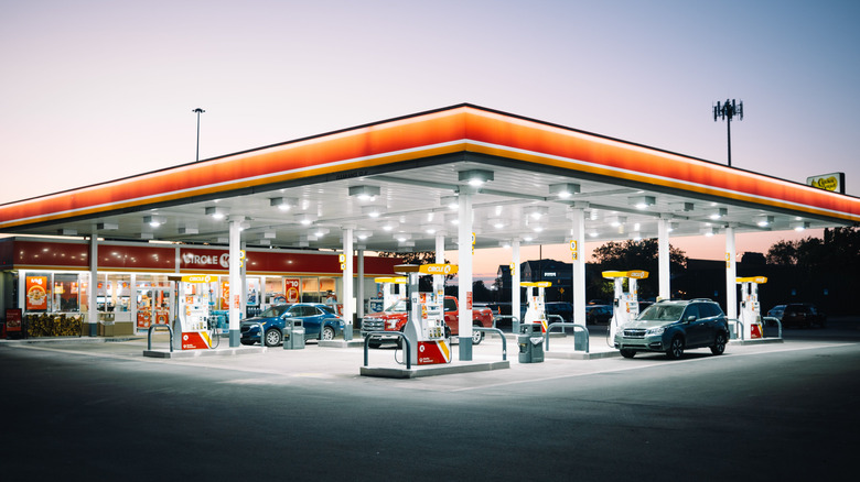 Gas station at dusk with a few cars at the pumps