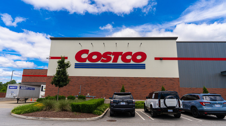 Cars parked in front of a Costco with blue skies