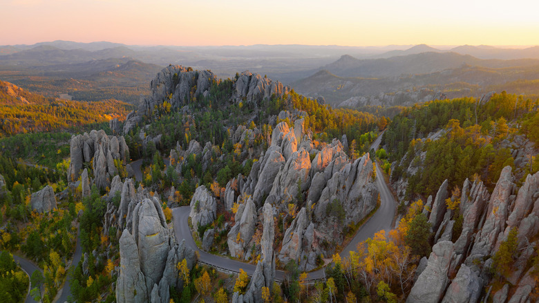 An aerial view of Needles Highway winding through the rugged granite spires of Custer State Park