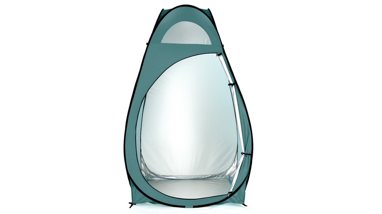 A green-colored standup privacy tent with the door open