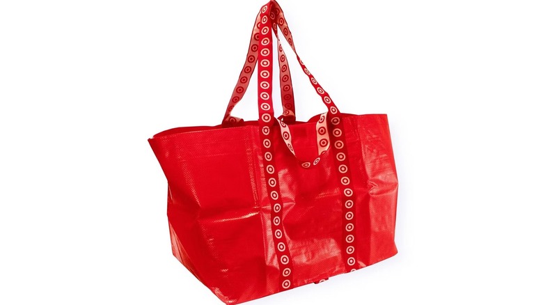 A red reusable tote with the Target logo on the straps