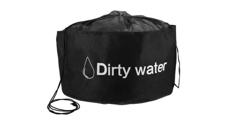 A soft-sided black bag with a drawstring that reads "Dirty water"