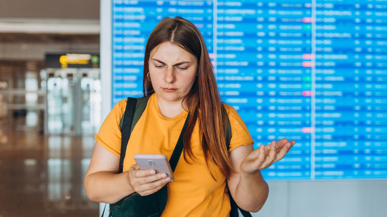 Airport traveler checking alternate flights