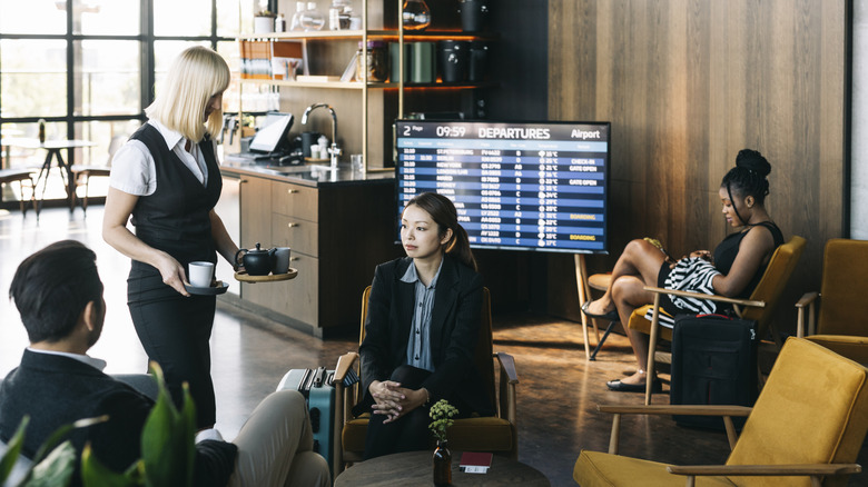 Travelers relaxing in airport lounge