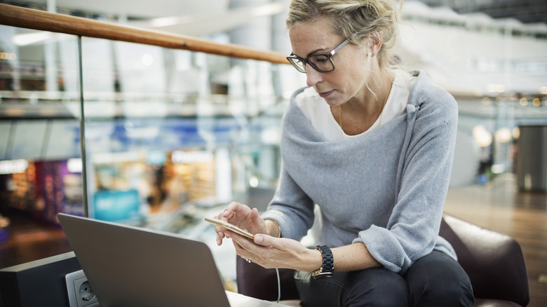 Traveler checking flight information at airport