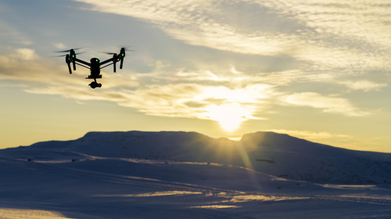 A drone flying over a mountainous landscape