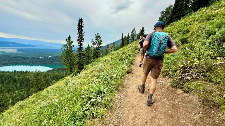 Hikers on the Lupine Meadow Trail to Delta Lake at Grand Teton National Park