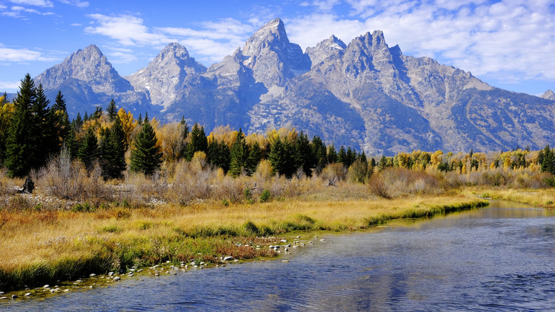The Teton Mountain Range in autumn with the Snake River in the foreground