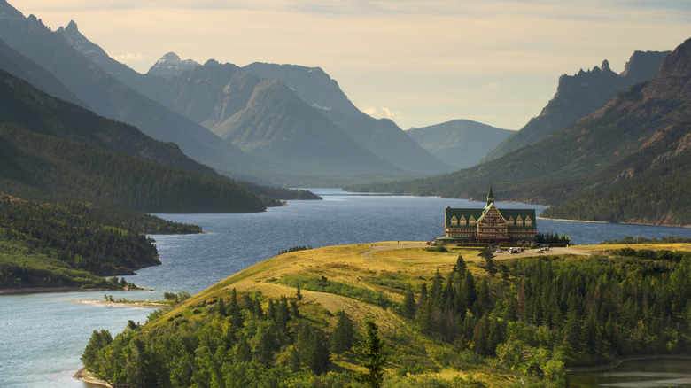 A view of Upper Waterton Lake during the early morning with a landmark hotel on a peninsula in the foreground